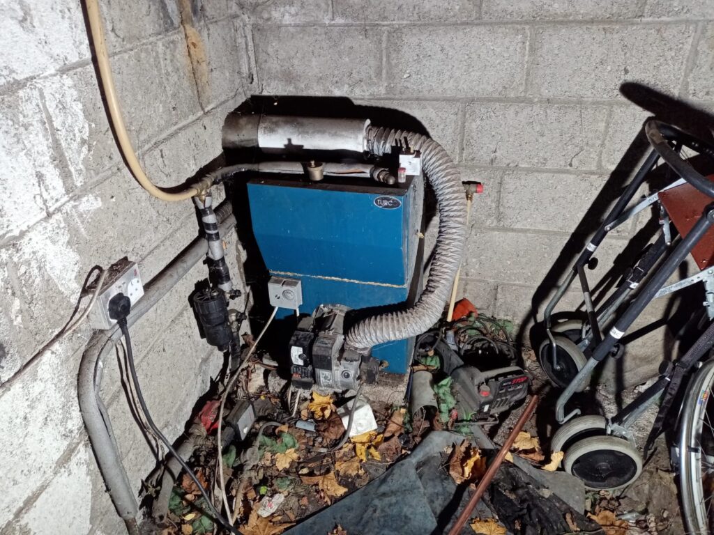 Outdoor Garage Located Warmflow New Oil Boiler Replacement - Before Photo
